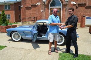 2013 Corvette winner Steve Lane of Chesaning, MI receives the keys from Father Chris Forler at St. Bernard Church on July 19th.